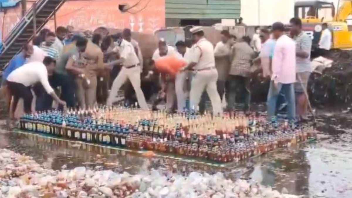 andhra-cops-helpless-as-locals-steal-liquor-bottles-set-aside-to-be-destroyed-by-bulldozer